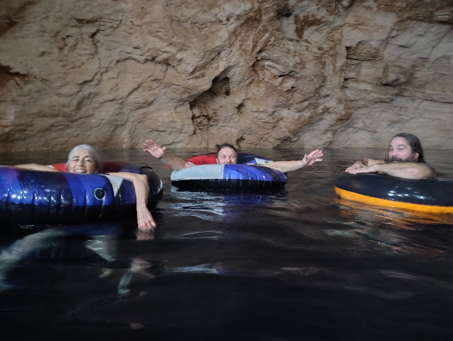 A picture of Beth, Diego and Sundance in innertubes in David’s cenote.
