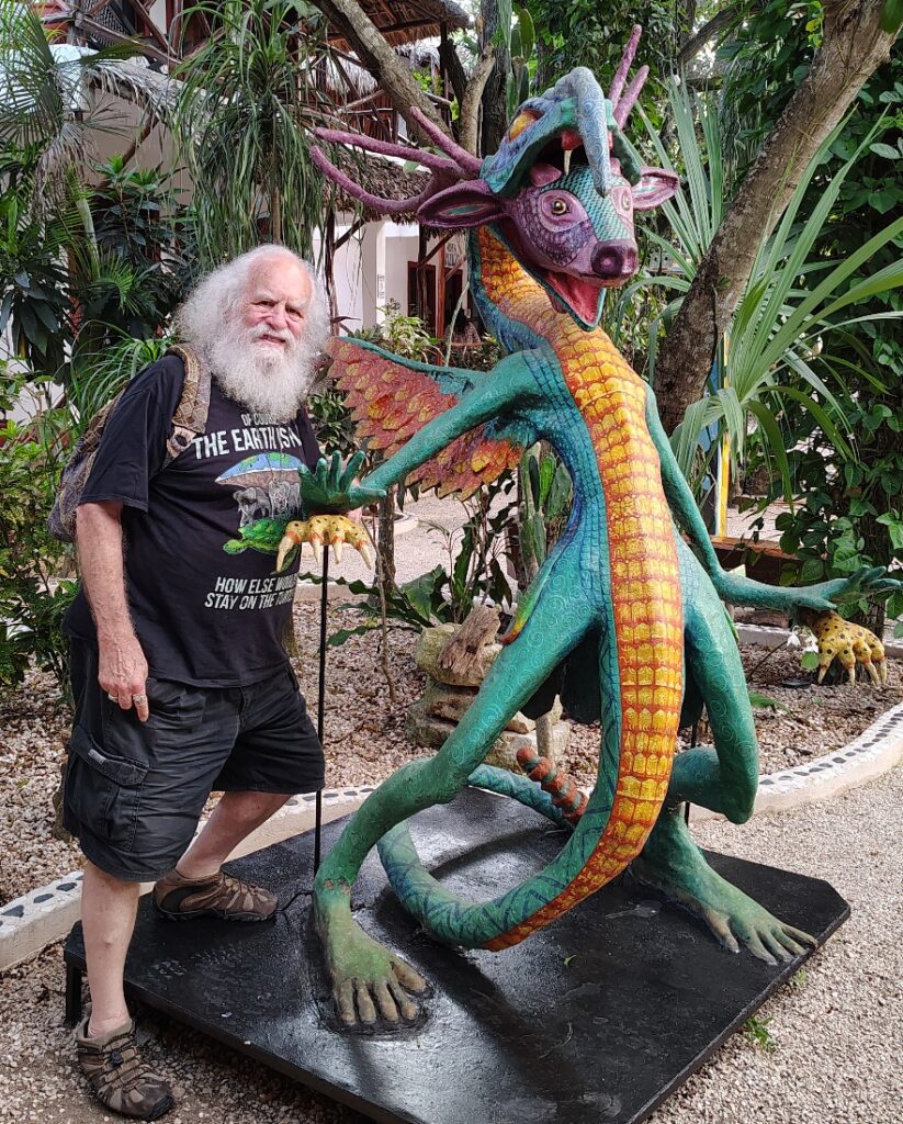 Photo of OZ standing next to a creature sculpture at Hotel Zentik.