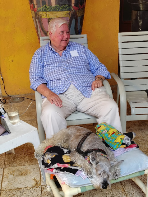 Photo of John Venator, owner of Casa de Los Venados sitting with his dog.