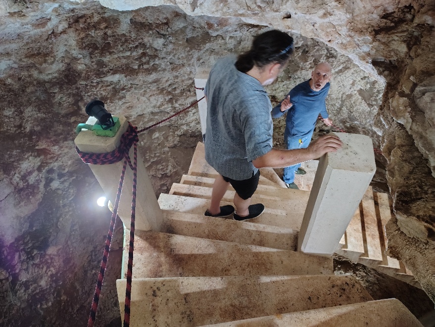 A picture of Diego and David descending the stairs into David's Cenote
